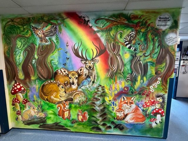Colourful hospital wall mural wih woodland animals and trees
