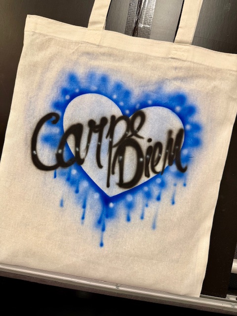 Tote bags with guest names airbrushed at a London university event